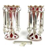 A pair of Bohemian cranberry and white overlay glass lustre vases, with arcaded rims and gilt