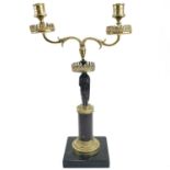 A French bronze and ormolu figural candelabrum, circa 1900, with twin branches supported by a