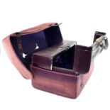 An early 20th century Harrods Ltd plum leather Gladstone type vanity case with purple silk inner