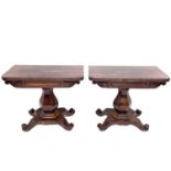 A pair of early Victorian rosewood tea tables, with fold-over tops on stout hexagonal baluster