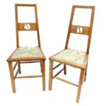 A pair of Arts and Crafts oak side chairs, the tapered backs with central slats and upright wave