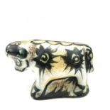 A Celtic, Newlyn pottery bull decorated in the folksy pattern, height 14.5cm length 24cm.