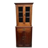 A Victorian mahogany two-part cabinet, of small proportions, the upper part with two glazed doors,
