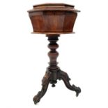 A Victorian walnut octagonal teapoy, the hinged top revealing two lidded containers and recesses for