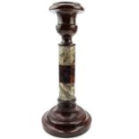 A Cornish serpentine candlestick, raised on a banded octagonal column and turned base, height 28.