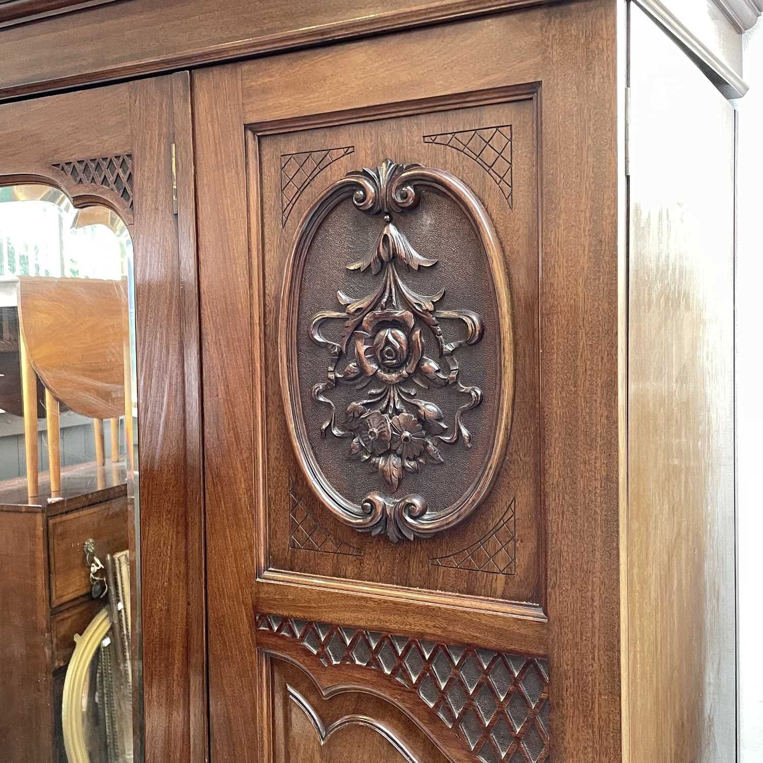 A late Victorian walnut triple wardrobe, with floral carved and mirrored panels enclosing hanging - Image 4 of 5