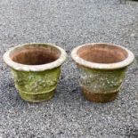 Two matched terracotta urns moulded with floral swags, height 49cm diameter 61.5cm
