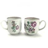 A pair of Bow porcelain cups, circa 1760, with strap handles and floral polychrome decoration,