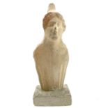 A Cypriot limestone half length votive figure carved with a conical headdress on square plaster
