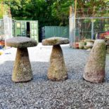 Two circular granite staddle stones with tapered bases, height approx 67cm together with another