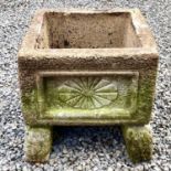 A reconstituted stone rectangular planter with indented moulded decoration raised upon a pair of