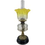 A Victorian glass and brass oil lamp, with a graduated yellow glass shade and fitted a Pasley