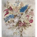 A 19th century woolwork embroidery of a floral display, 67cm x 61cm.