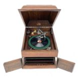 An HMV oak table top wind-up gramophone, height 36cm, width 3cm, depth 47cm.