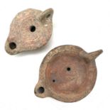 A Roman terracotta oil lamp moulded with wheat design diameter 10cm together with another Roman