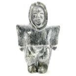 An Inuit soapstone carving of a standing woman in an Amuati signed H A L? Coppermine, possibly by