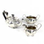 An Edwardian silver three piece tea set by J Gloster Ltd.