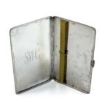 A large silver engine turned cigarette case.