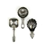 A George V silver caddy spoon with shell bowl and two continental silver caddy spoons.