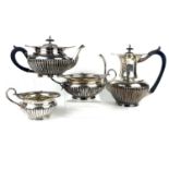 An Edwardian silver four piece tea set by Walker & Hall.