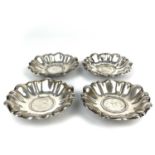 A set of four Continental silver lobed pin dishes inset with 2 schilling coins.