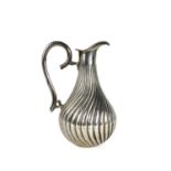 A 20th century Columbian 0.900 silver wrythen fluted jug.