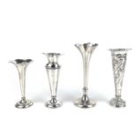 Four silver bud vases, three with weighted bases.