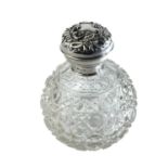 An Edwardian silver lid cut glass scent bottle.