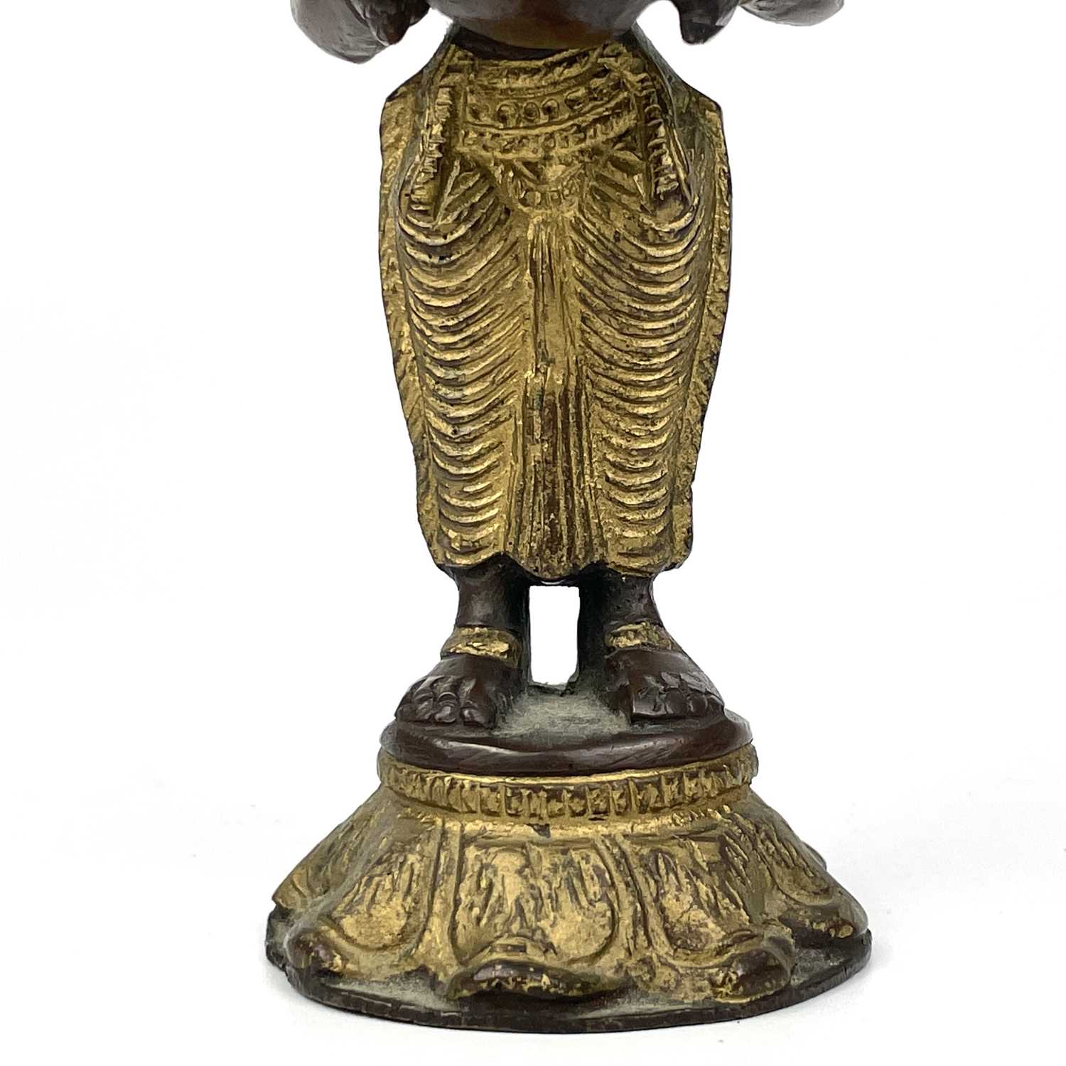 An Indian gilt bronze figural oil lamp. - Image 7 of 9