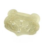 A Chinese carved pale jade buckle, Qing Dynasty.