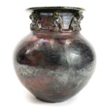An early 20th century Raku style Chinese vase with applied buddhas.