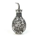 A Chinese silver cased glass perfume bottle, with prunus blossom decoration.
