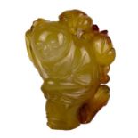 A Chinese jade and russet carving of a boy, Qing Dynasty.