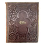 A Victorian scrap album bound in embossed leather.