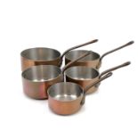 A graduated set of six French copper saucepans.