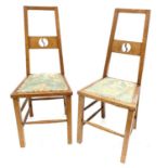 A pair of Arts and Crafts oak side chairs.