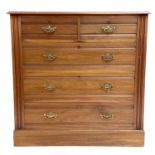 An Edwardian walnut chest.