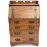 An Arts and Crafts oak writing bureau.