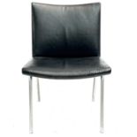 After Hans J Wegner, a mid-century chrome-edged leather chair.