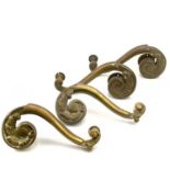 Two pairs of brass theatre door handles.