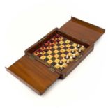 A mahogany folding travel chess set.