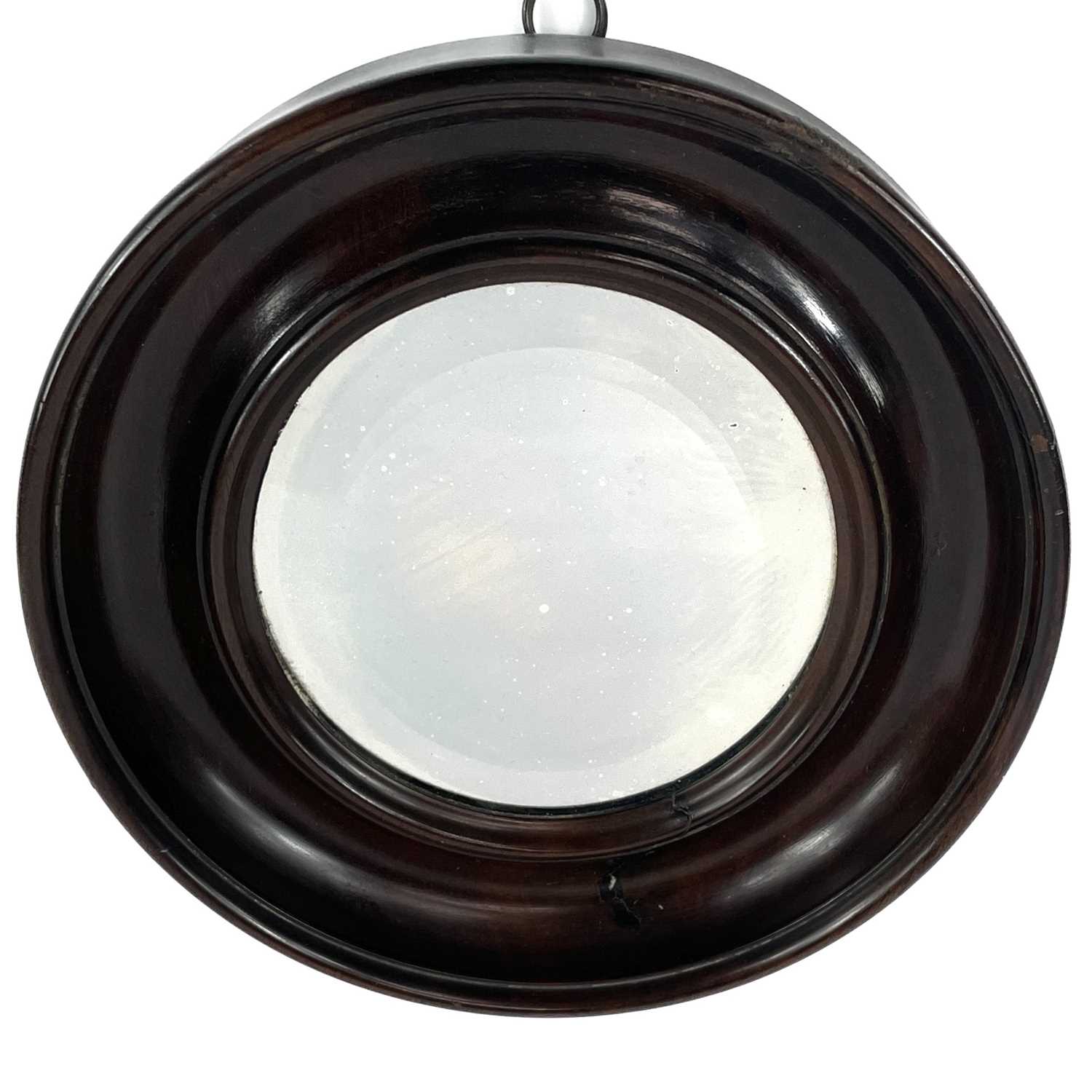 A small late 19th century circular bevelled edge mirror in a mahogany frame.