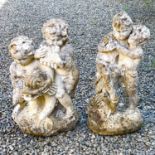 A reconstituted stone fountain, modelled as putti playing pan pipes.