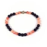 A coral and garnet bead bracelet with 9ct clasp.
