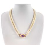 A 1960's cultured pearl graduated double row necklace with 9ct amethyst set clasp.