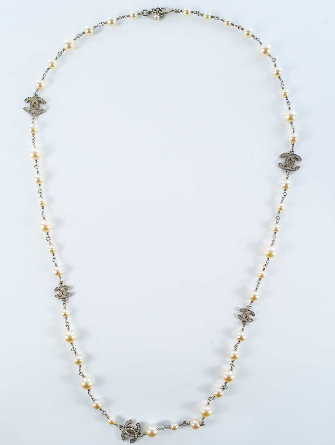 A Chanel white metal cultured pearl and white gem set CC long necklace. - Image 2 of 4