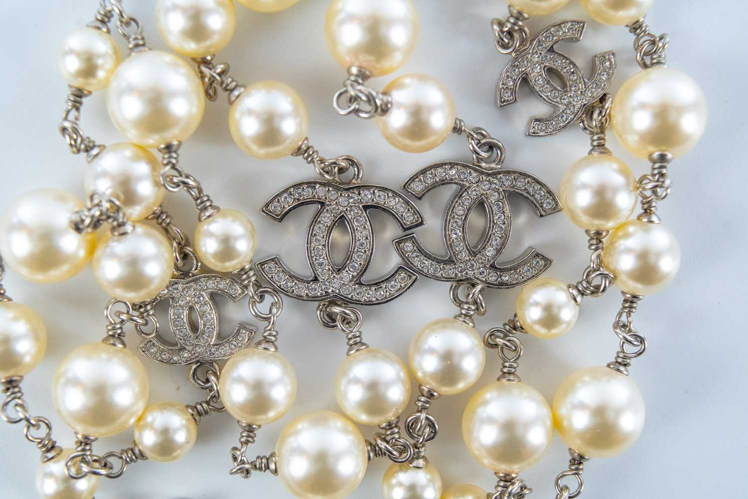 A Chanel white metal cultured pearl and white gem set CC long necklace. - Image 3 of 4