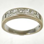 An 18ct white gold diamond square cut set seven stone half eternity ring.