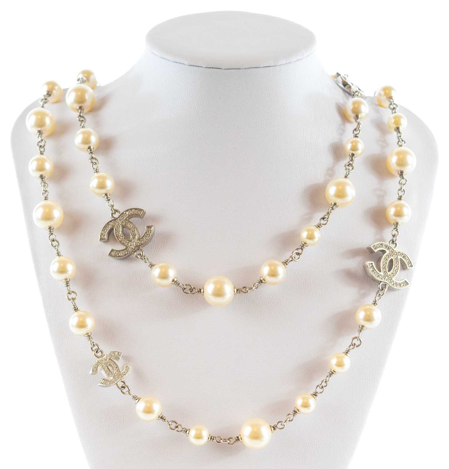 A Chanel white metal cultured pearl and white gem set CC long necklace.