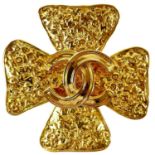 A Chanel gold plated clover brooch.